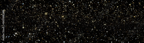 Black background with gold and white glitter of various sizes and shapes scattered randomly throughout.