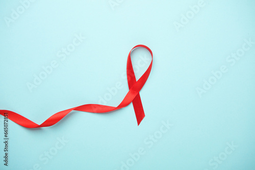 Red AIDS Awareness Ribbon on Blue Background