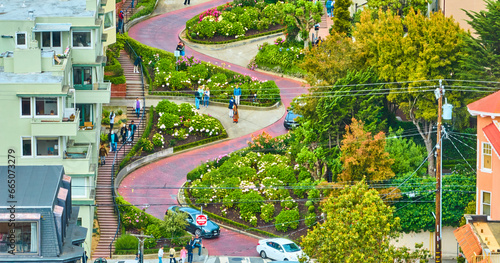 Aerial people and cars navigating Lombard Street zoomed in view of winding red brick road photo