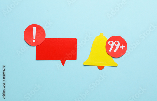 Paper cut notification bell iand speech bubble on on blue background photo