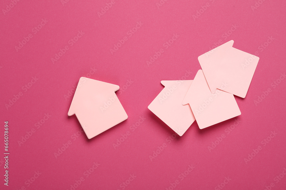 Memo papers in the shape of a house on a pink background Memo papers in the shape of a house on a pink background