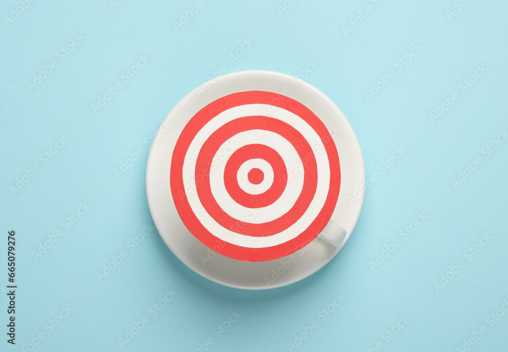 Target with cup on a blue background. Business concept Target with cup on a blue background. Business concept