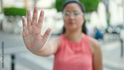 Wallpaper Mural Young chinese woman doing stop gesture with hand at street Torontodigital.ca
