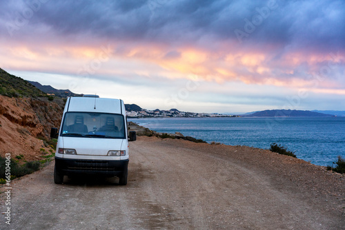 Van by the sea on a dirt road