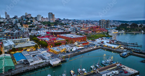 Aerial city lights in San Francisco at dusk near Hyde St Pier and Fishermans Wharf on coast