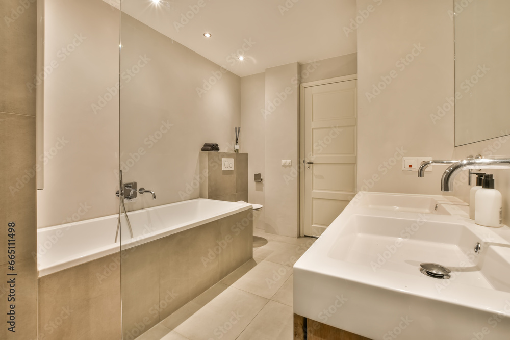 White bathroom with ceramic bathtub and sink White bathroom with ceramic bathtub and sink