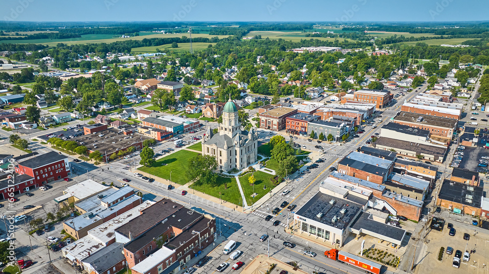 Wide aerial view of Columbia City and Whitley County courthouse on bright sunny day