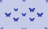 Seamless pattern of large isolated blue butterfly symbols. The pattern is divided by a line of elements of lighter tones. Vector illustration on light blue background