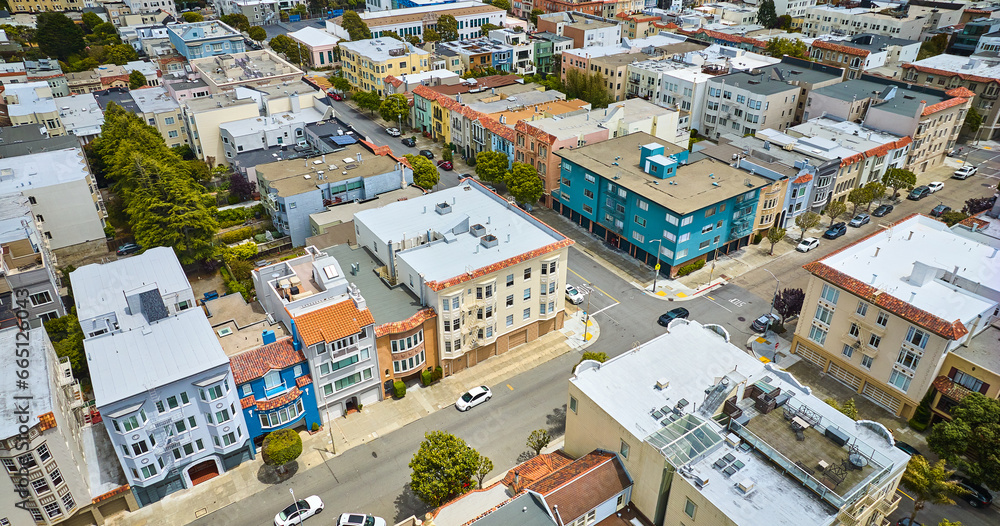 Downward aerial residential buildings in San Francisco with crossing intersection in roads