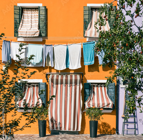 colorful house facade with clothing drying in Burano Venice