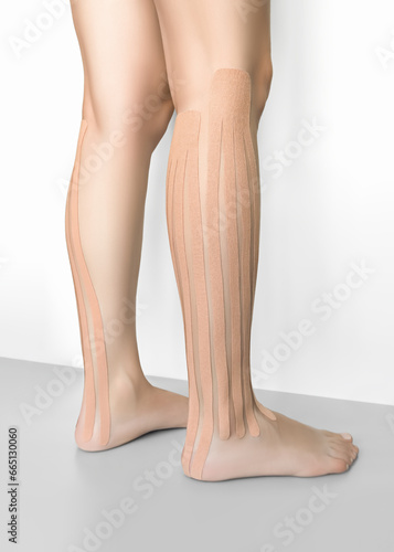 female legs with beige kinesio tapes. lymphatic drainage legs taping