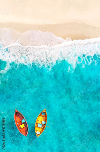 Aerial View of Sandy Tropical Beach and Ocean with Red and Yellow Boats Floating on Turquoise Water. Summer Poster Background.