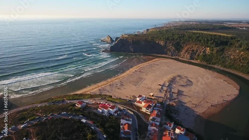 Aerial video filming by drone of the sea bay and beach near the village of Odeceixe Alentejo Portugal. During sunset, moving in a circle