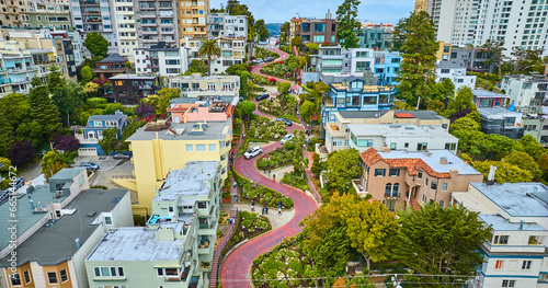 Gorgeous wider aerial of iconic Lombard Street with buildings on either side of red brick road photo