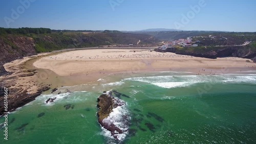 Aerial video filming by drone of the sea bay and beach near the village of Odeceixe Alentejo Portugal. Reefs in clear water