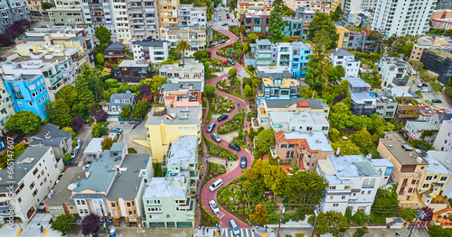 Aerial looking at Lombard Street and houses from further back with cars going down red brick road photo