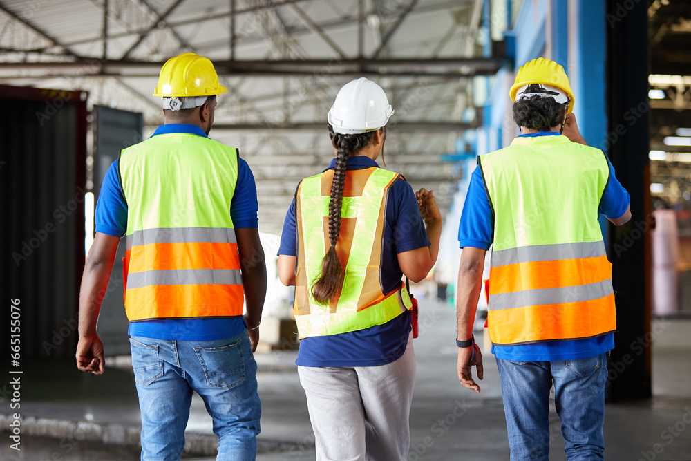 back view workers walking and talking about work or project in the warehouse storage back view workers walking and talking about work or project in the warehouse storage