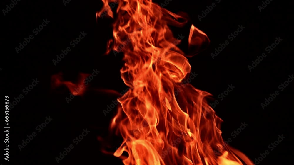 Beautiful flame of burning campfire rising up. Fire isolated on black backdrop. Close up. Beautiful flame of burning campfire rising up. Fire isolated on black backdrop. Close up.