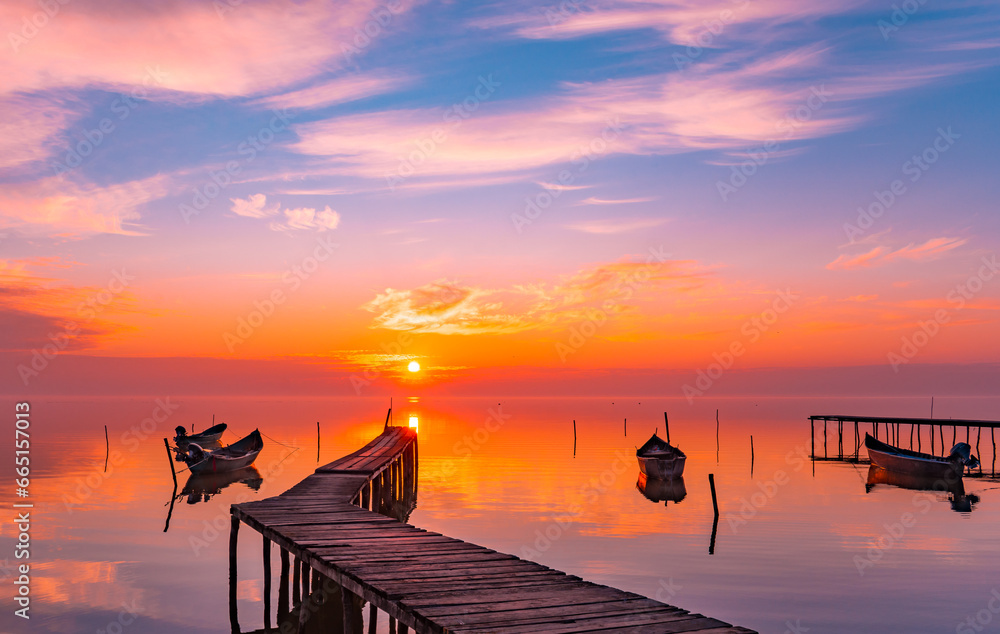 sunrise with boats on the lake