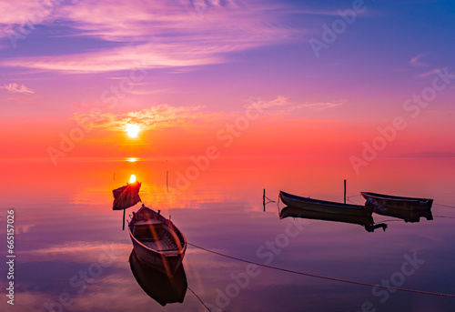 sunrise with boats on the lake