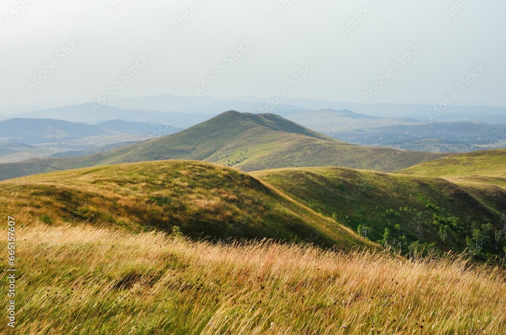 AI generated illustration of a grassy hillside overlooking the distant mountain range AI generated illustration of a grassy hillside overlooking the distant mountain range