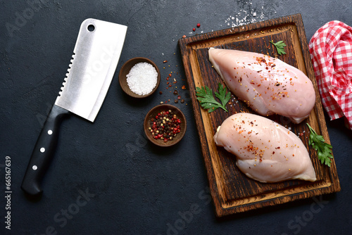 Raw organic chiken breasts with ingredients for making. Top view with copy space. photo