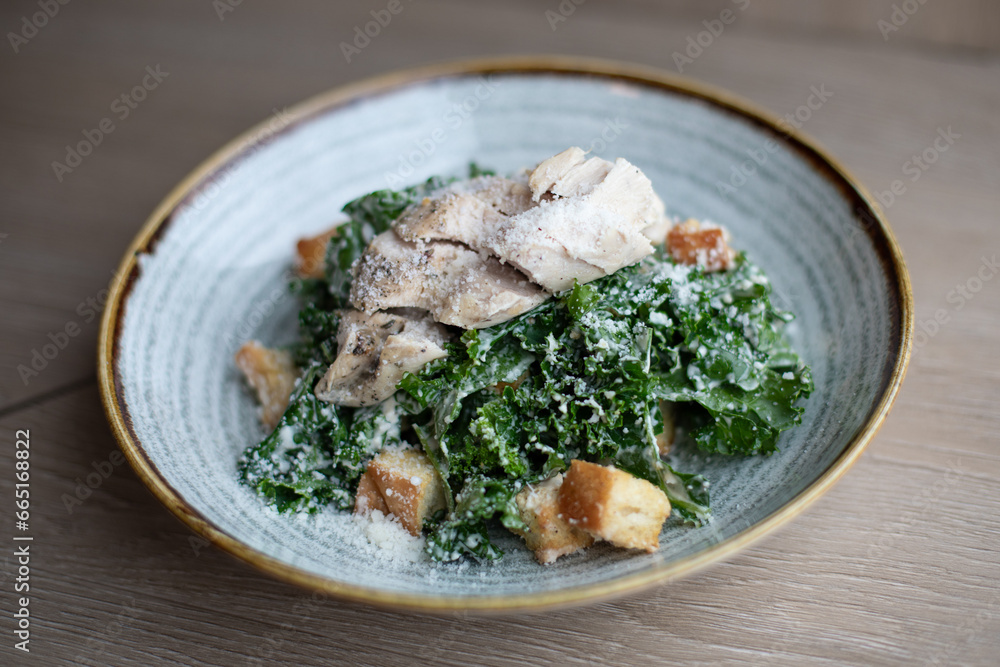 Sous Vide Chicken Over Kale Caesar Salad in a Light Blue Bowl Sous Vide Chicken Over Kale Caesar Salad in a Light Blue Bowl