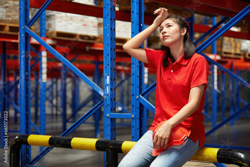 factory worker feeling tired from hard work in the warehouse storage