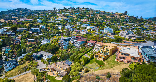 Aerial Tiburon houses on hillside and city skyline with blue sky and white clouds