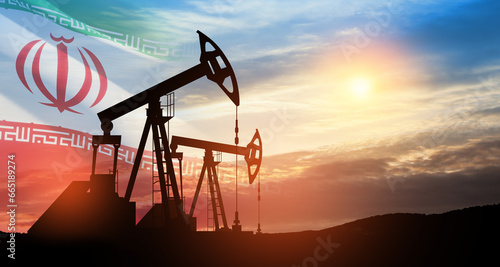 Oil drilling derricks at desert oilfield with Iran flag. The change in oil prices caused by the war. Oil prices are rising because of the global crisis. Crude oil production from the ground.