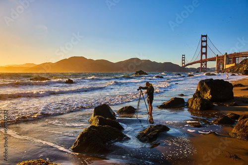 Photography Photographer on Marshalls Beach capturing golden sunset with Golden Gate Bridge