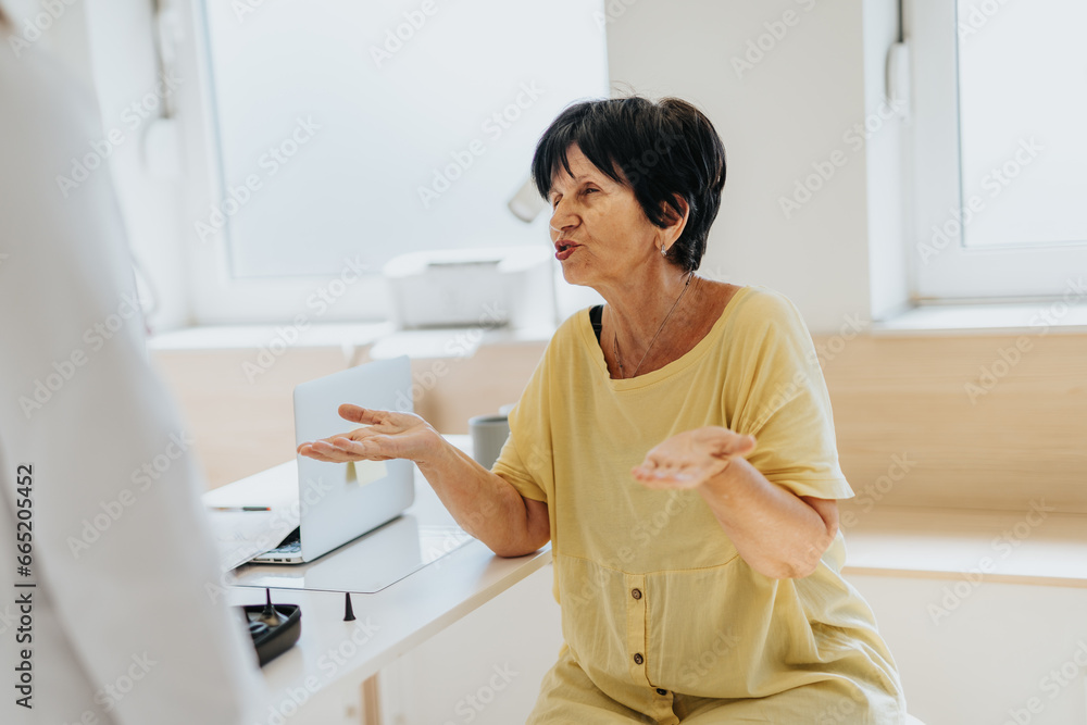 Elderly female patient telling health problems to her doctor. Elderly female patient telling health problems to her doctor.