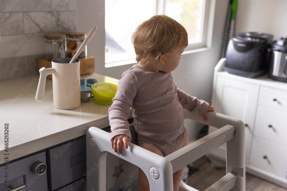 Toddler playing in the kitchen with household objects Toddler playing in the kitchen with household objects
