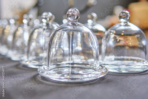 Restaurant kitchen counter with glass cloches for smoking food. Creative cooking tools.