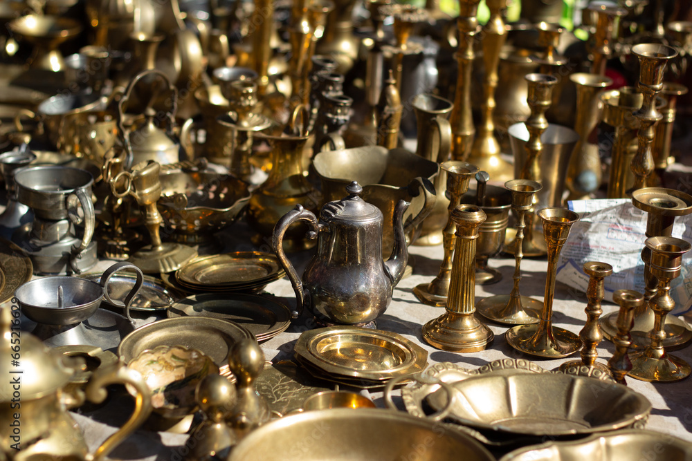 Street photo. Tin, bronze, copper dishes, teapot, plate, ladle, frying pan, saucepan. Swap meet. Flea market. Sale of old, antique, vintage items. Concept of reuse, ecology, shopping, antiques, food Street photo. Tin, bronze, copper dishes, teapot, plate, ladle, frying pan, saucepan. Swap meet. Flea market. Sale of old, antique, vintage items. Concept of reuse, ecology, shopping, antiques, food