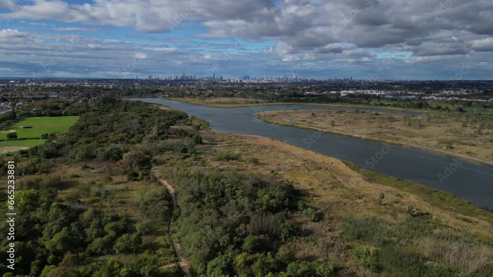 aerial lowering shot of new york city skyline from a distance (far away in marine park, brooklyn) with marsh wetland in the foreground drone footage aerial lowering shot of new york city skyline from a distance (far away in marine park, brooklyn) with marsh wetland in the foreground drone footage