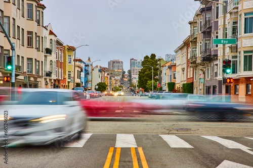 Photography Blur motion of moving vehicles through San Francisco intersection with long road