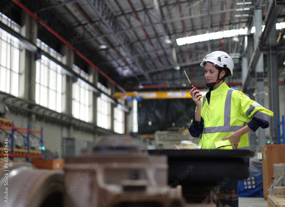 Portrait of a female electrical engineer using radio communication at the Rail train service station Portrait of a female electrical engineer using radio communication at the Rail train service station
