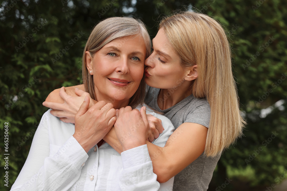 Happy mature mother and her daughter outdoors Happy mature mother and her daughter outdoors