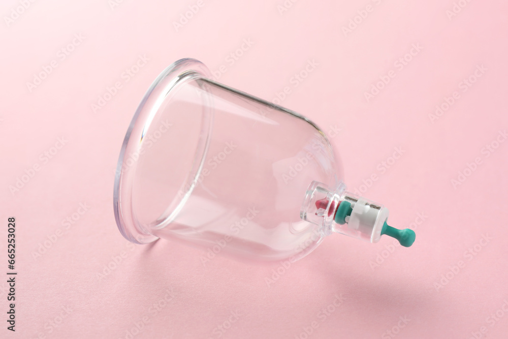Plastic cup on pink background. Cupping therapy Plastic cup on pink background. Cupping therapy