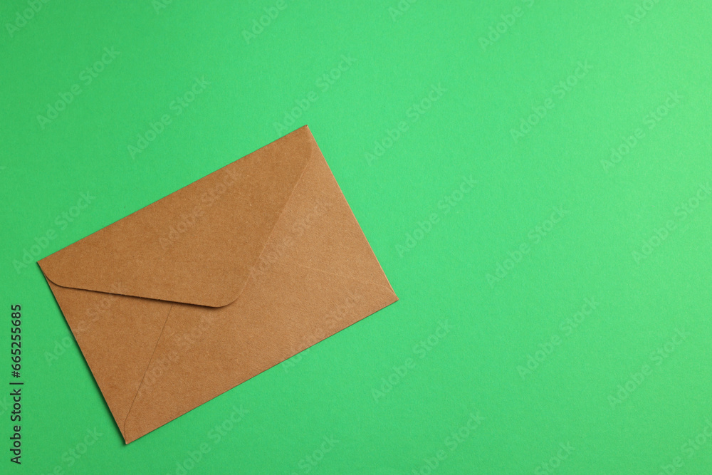 Envelope made of parchment paper on green background, top view. Space for text Envelope made of parchment paper on green background, top view. Space for text