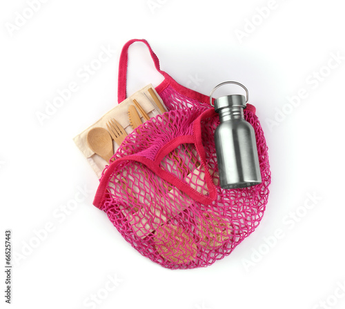 Mesh bag with different items isolated on white  top view. Conscious consumption