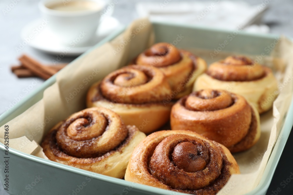 Baking dish with tasty cinnamon rolls on table, closeup Baking dish with tasty cinnamon rolls on table, closeup
