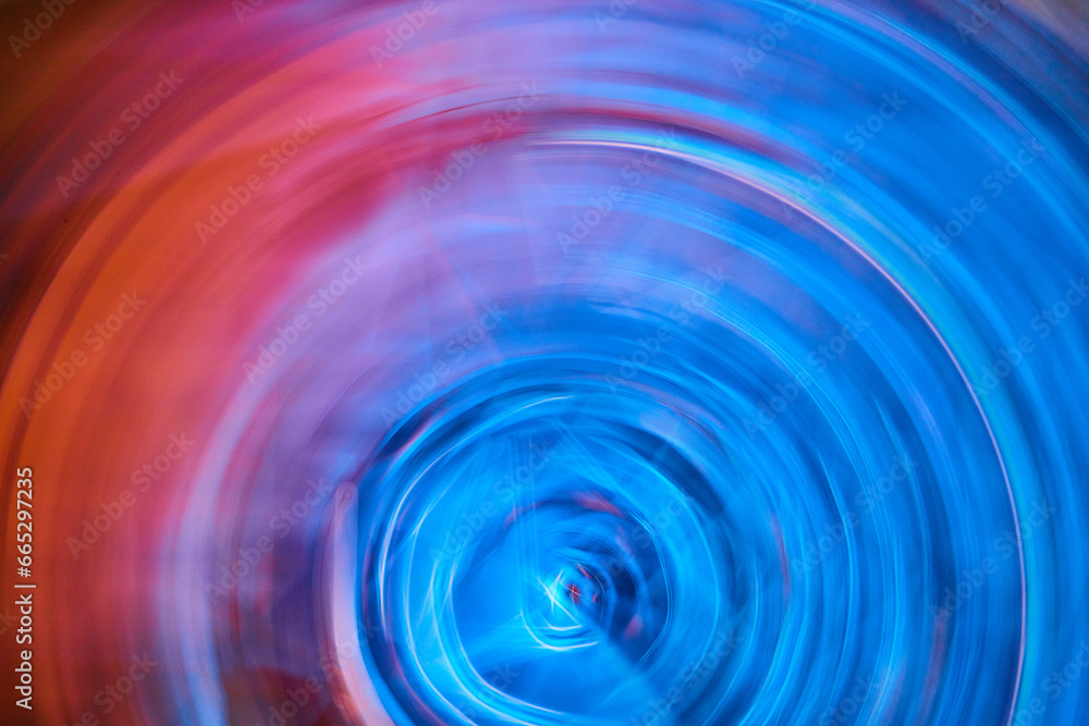 Bright neon blue ripple blur in artistic abstract artwork with orange flare on left side Bright neon blue ripple blur in artistic abstract artwork with orange flare on left side