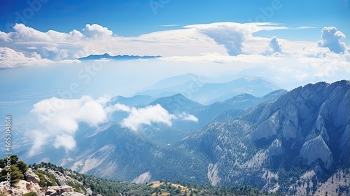 Beautiful natural panorama landscape - view from top of Tahtali mountain with beautiful blue sky with white clouds. Antalya, Turkey photo