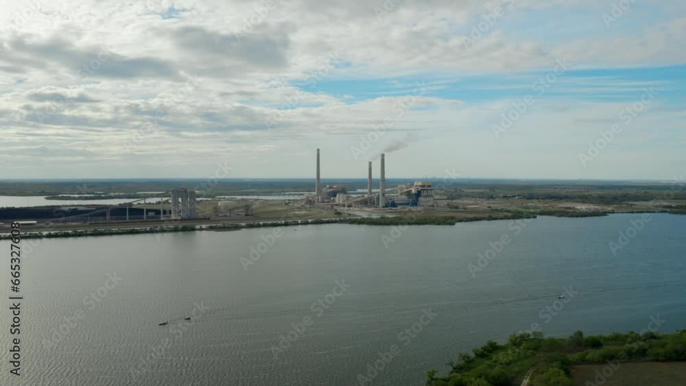 Power Plant with lake and boats - Drone shot track and orbit left v1 Power Plant with lake and boats - Drone shot track and orbit left v1