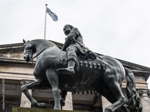 statue of Charles II with Scottish flag in background, Parliament Square, Edinburgh, Scotland photo