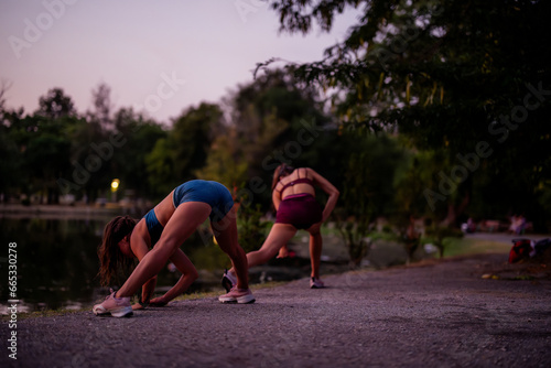 Gorgeous Women Exercising at Night in a Green Park