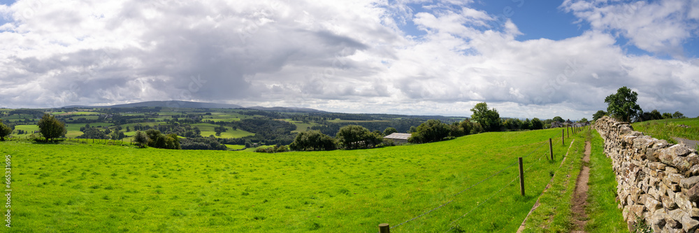 a panoramic view looking across pastures and farms on hill and dale in Cumbria, near Walton, UK a panoramic view looking across pastures and farms on hill and dale in Cumbria, near Walton, UK