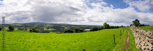 a panoramic view looking across pastures and farms on hill and dale in Cumbria, near Walton, UK